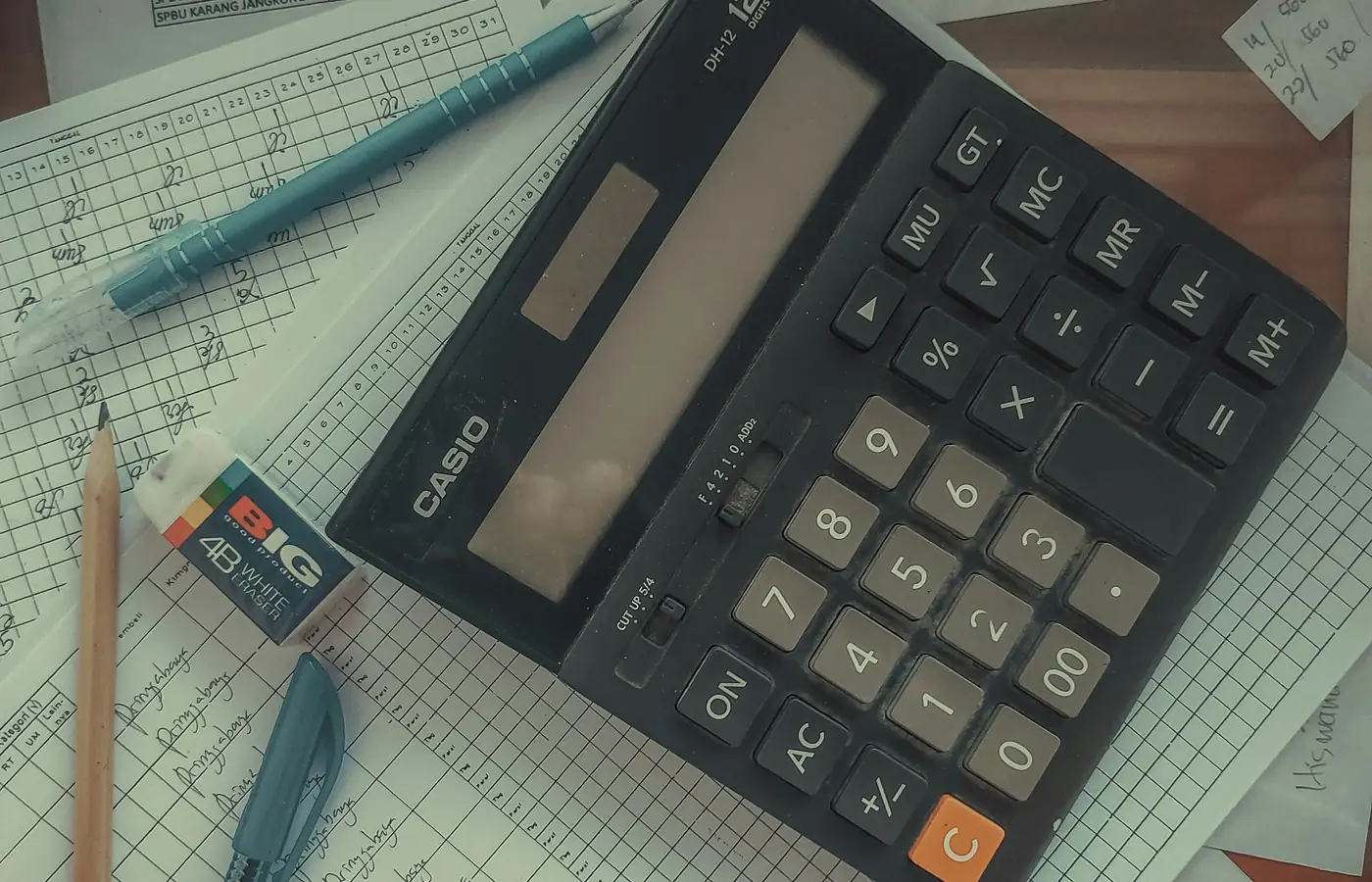 Calculator and handwritten records used for catch-up bookkeeping.